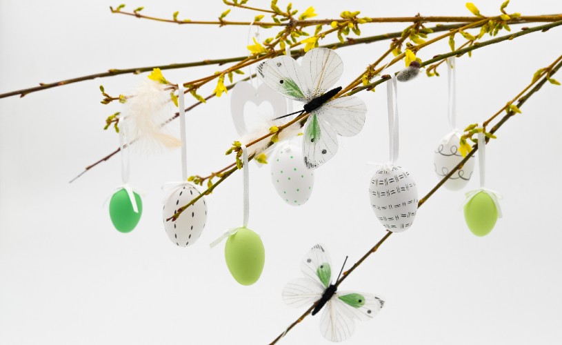 Butterfly and Easter egg decorations hanging on a tree
